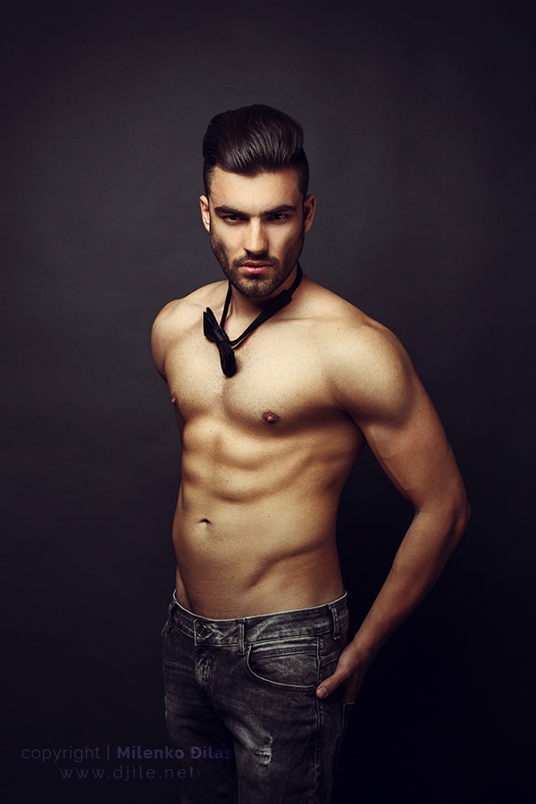 Handsome man posing in studio on dark background