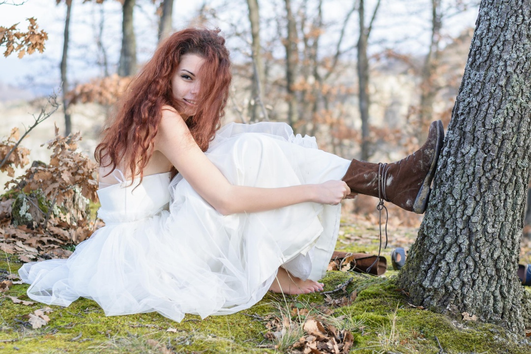 bride in the forest changing shoes