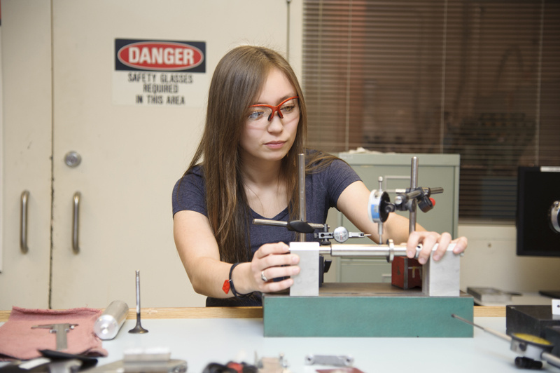 Woman working with a tool.