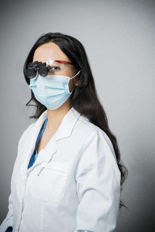 Dentist with magnifying glasses on.