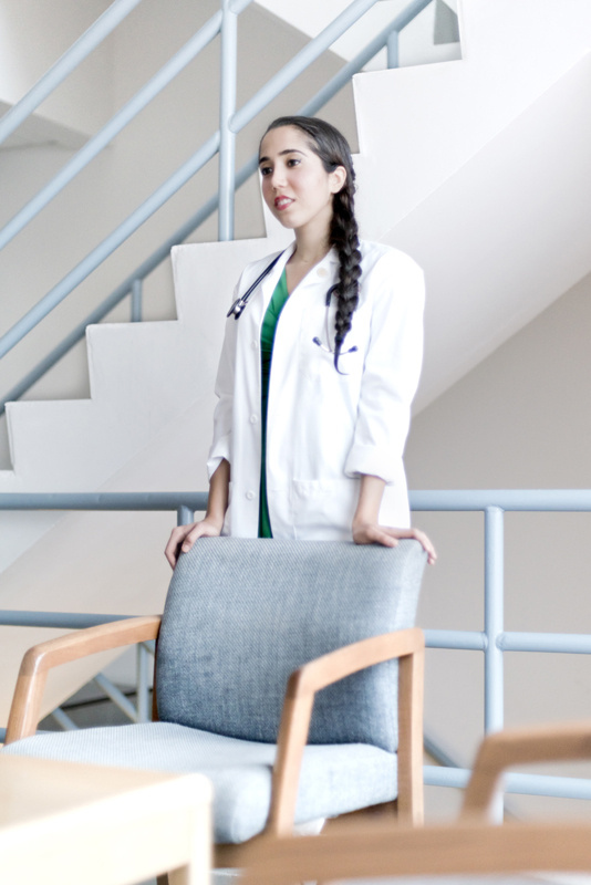 Medical doctor cleaning on back of chair.