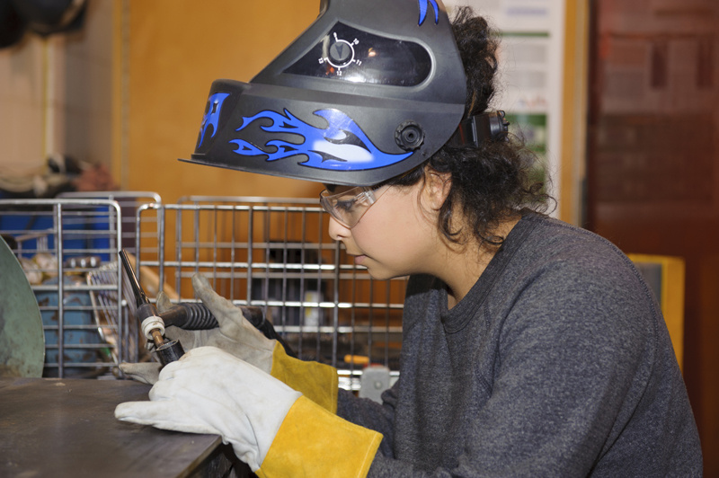 Woman preparing to weld.