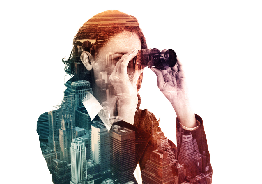 double exposure of businesswoman with binocular and megalopolis