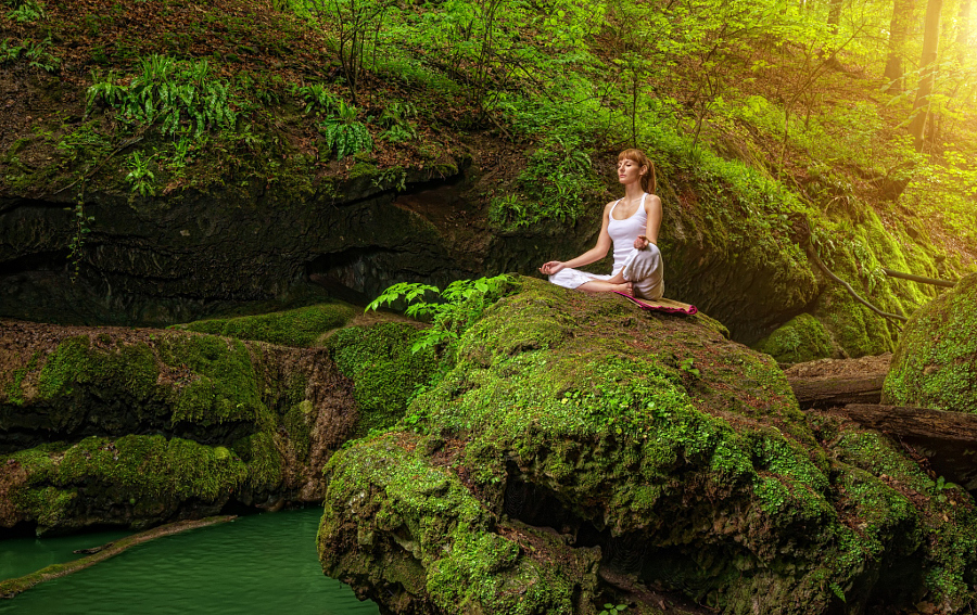 Relaxation in forest at the Waterfall. Ardha Padmasana pose.