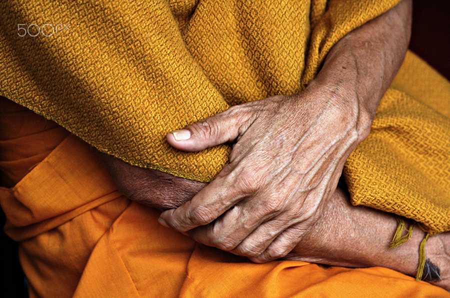 Old Buddhist monk's hands 