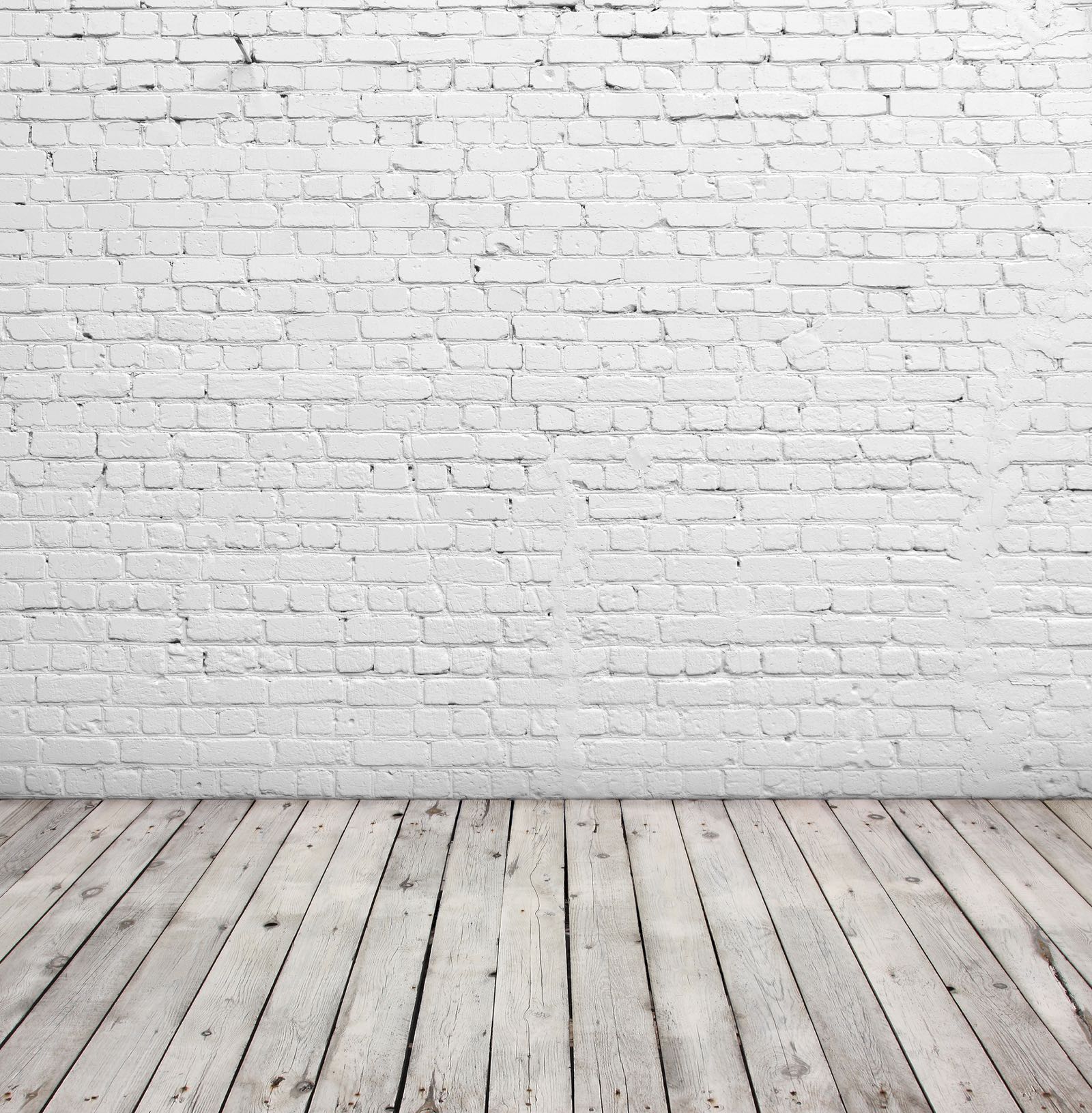 Old white brick wall and wood floor.