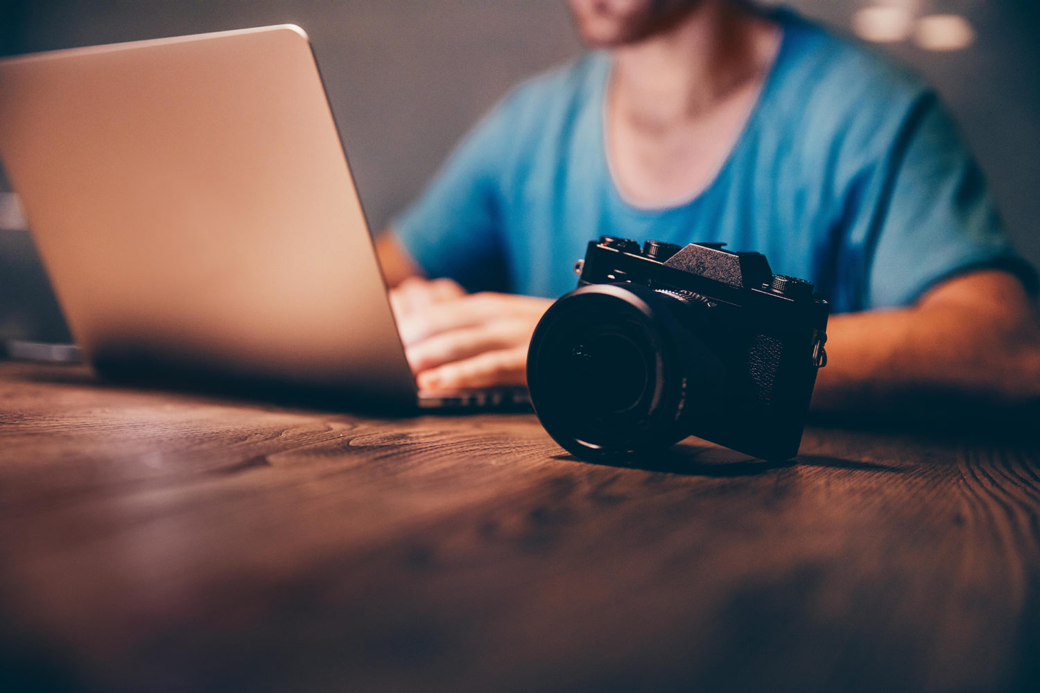 Man doing postproduction of his photos on laptop at night By Carina Konig