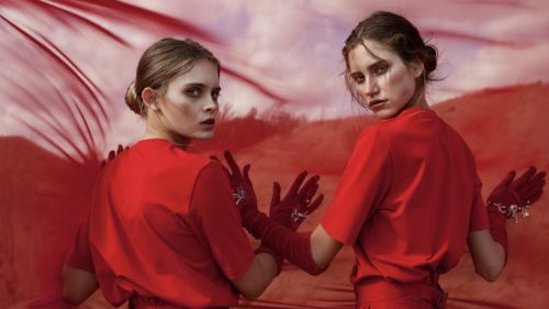 Two women in red dresses and gloves