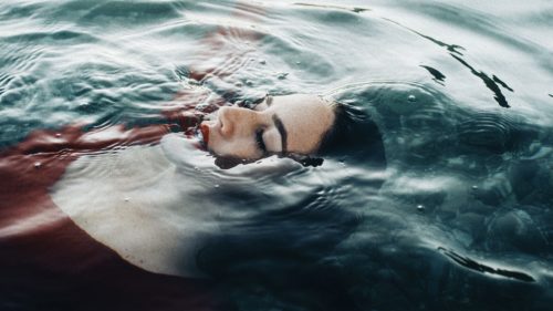 Women in red floating in the water