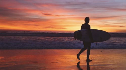 Surfer at sunset on Venice Beach