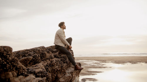 Portrait of young biracial man at the beach