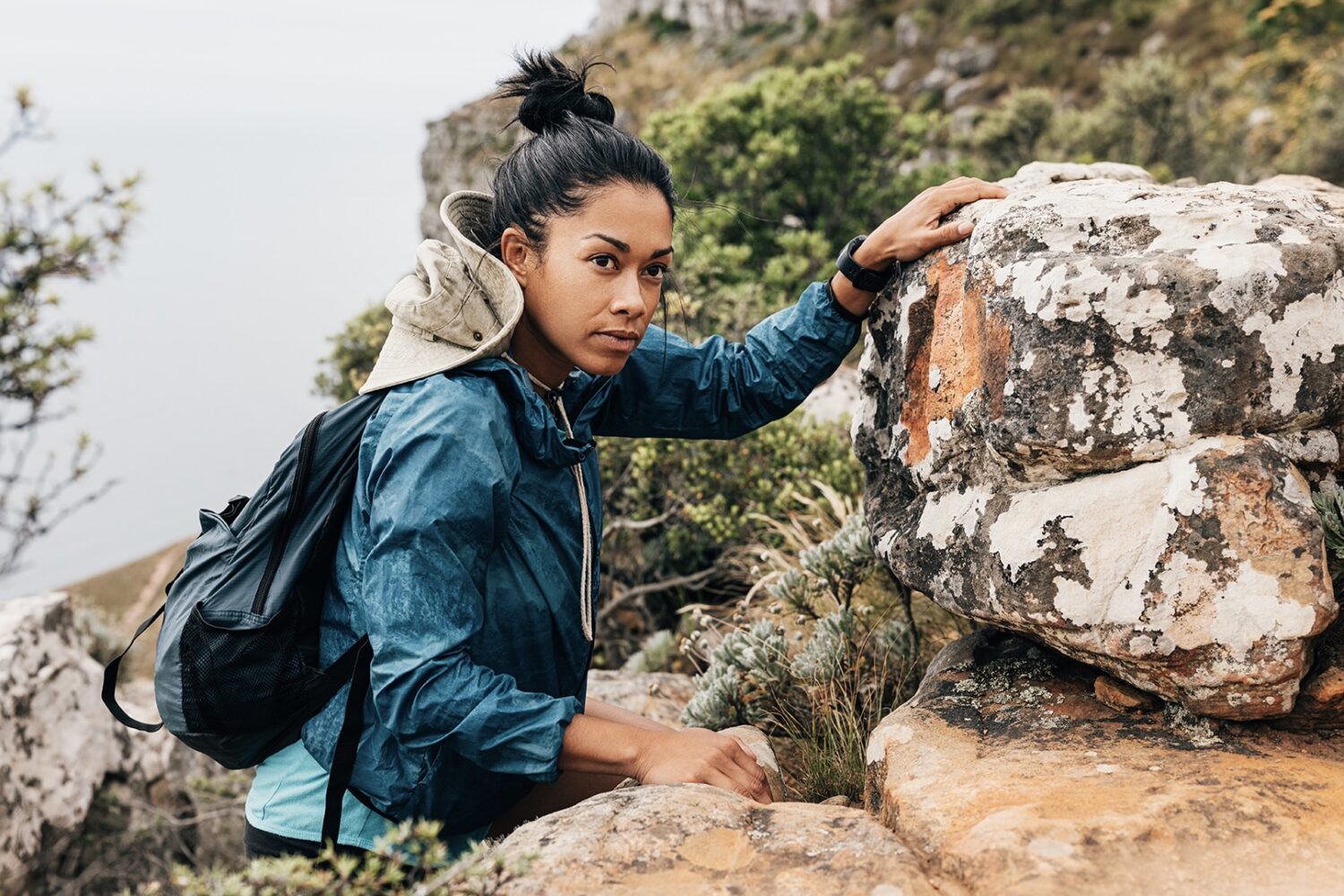 Portrait of woman hiker climbing rock and looking away. Young female hiking mountain. By Artem Varnitsin 2