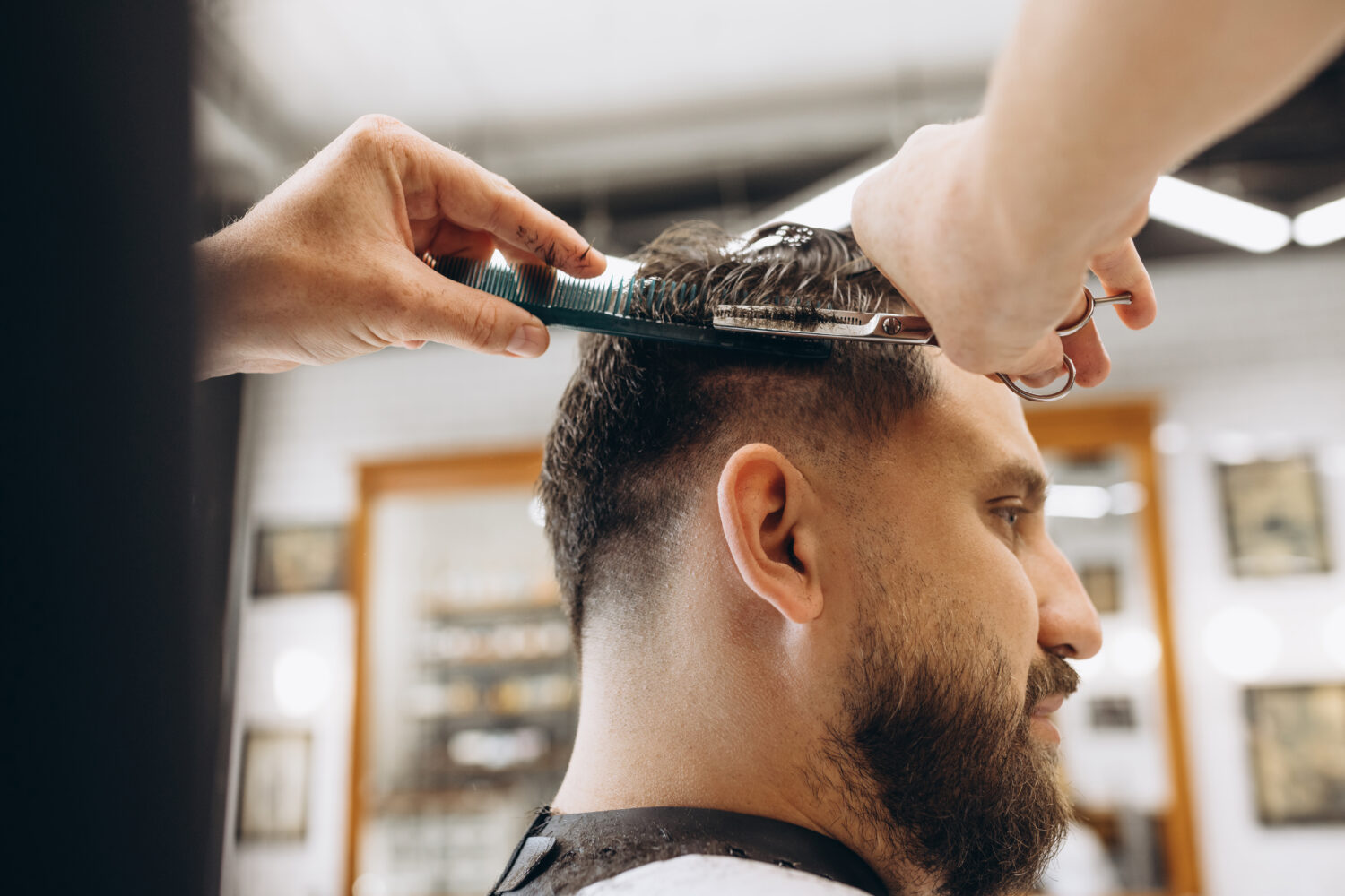 stock photo man getting haircut at the barbershop professional barber at work 1038077097