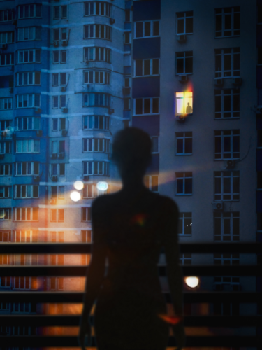 A silhouetted woman gazes out from a balcony, surrounded by the negative space of city high-rises.