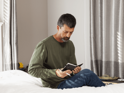 A photographer reflecting and journaling as part of a photography routine that fuels growth and long-term creative improvement.