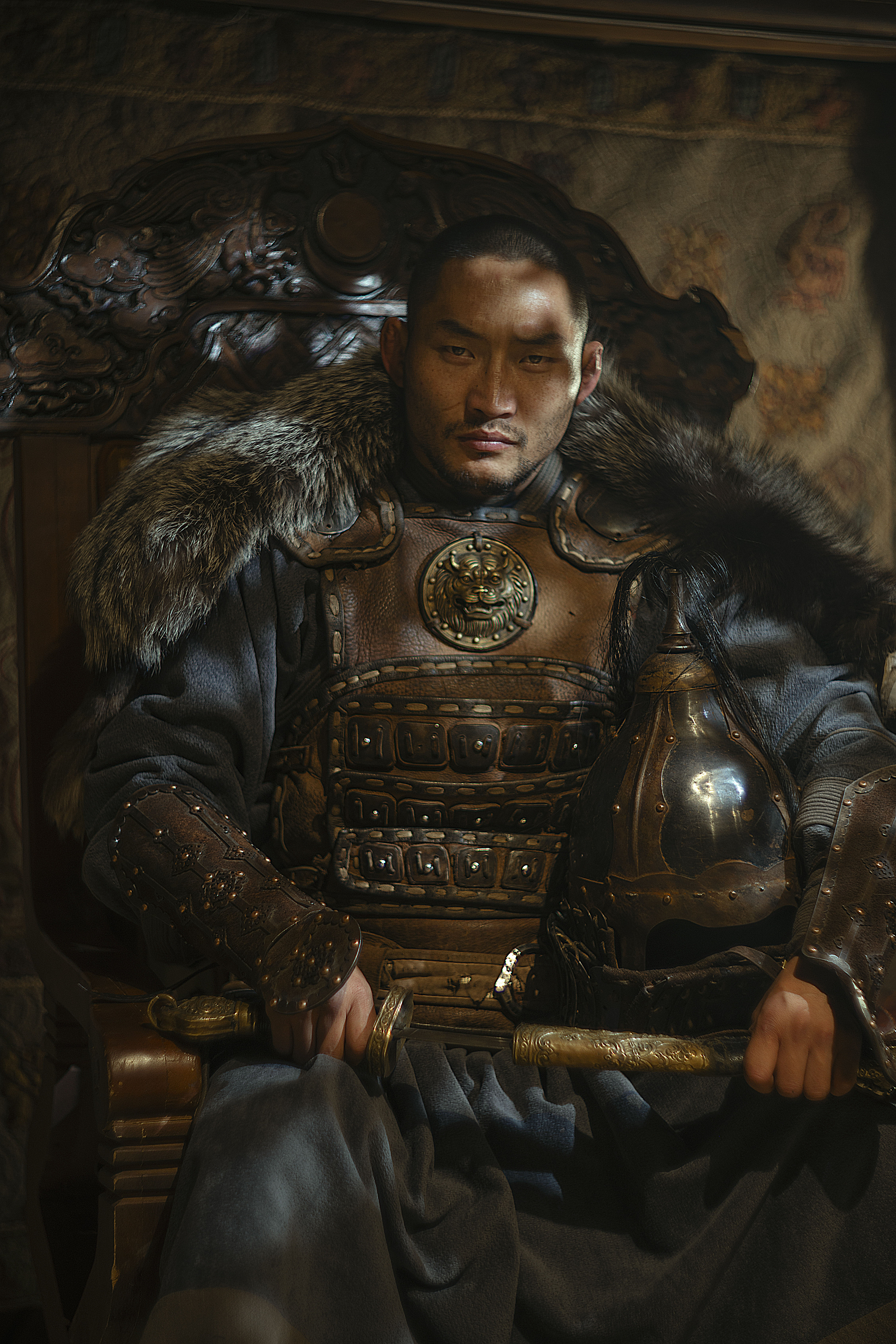 Portrait by Ganzorig Miimaa of a Mongolian warrior in traditional leather armor seated on a carved wooden throne, lit with warm cinematic lighting that highlights texture, strength, and heritage.