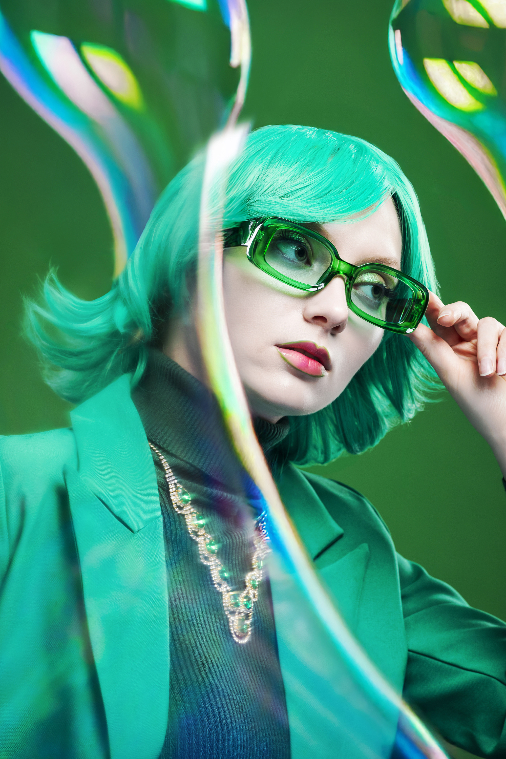 Olena Leliuk cinematic fashion portrait with bold green styling and reflective elements, highlighting creative composition and modern editorial photography