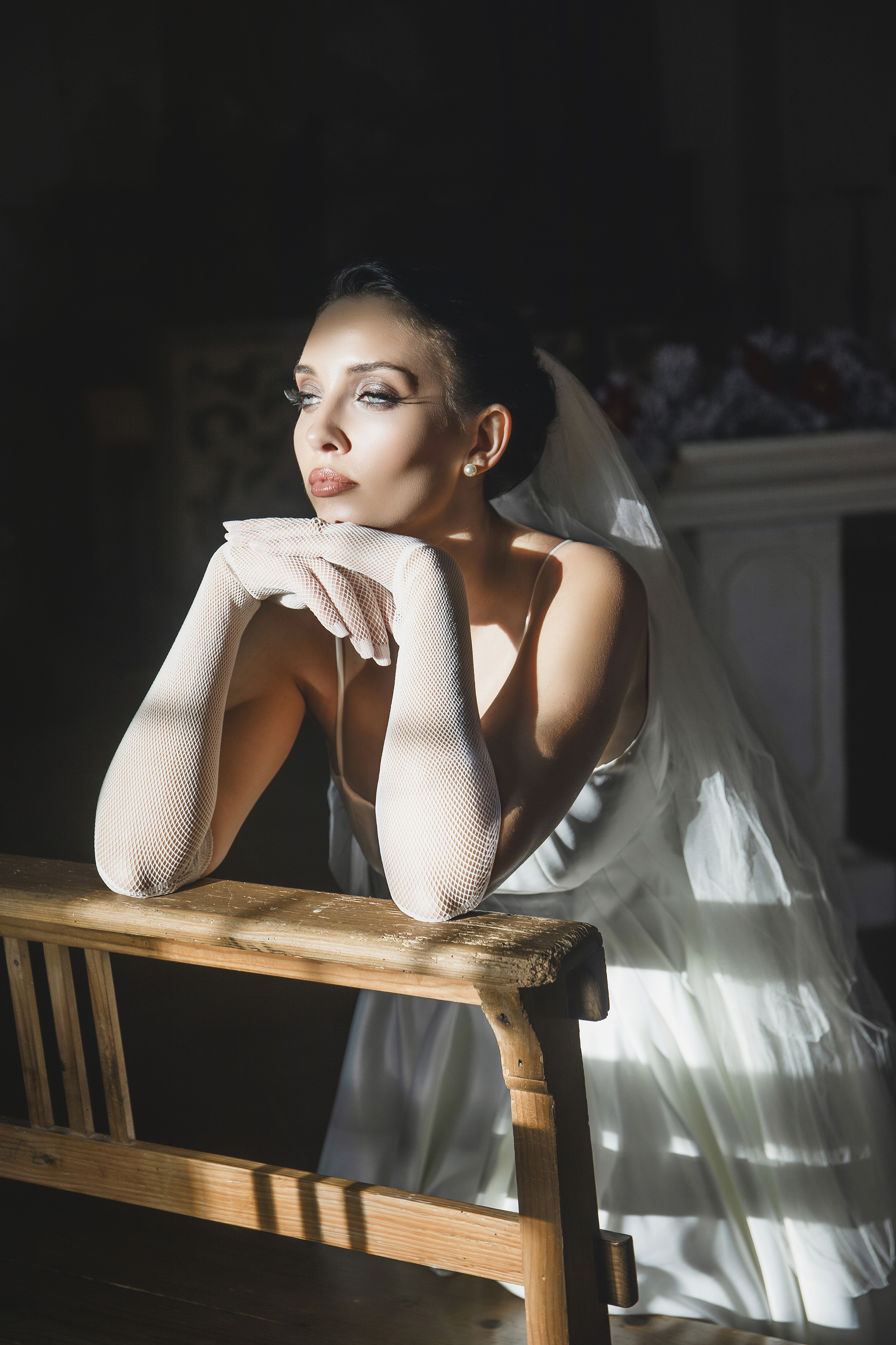 Olena Leliuk wedding photography portrait of a bride in soft window light, highlighting cinematic style and elegant composition