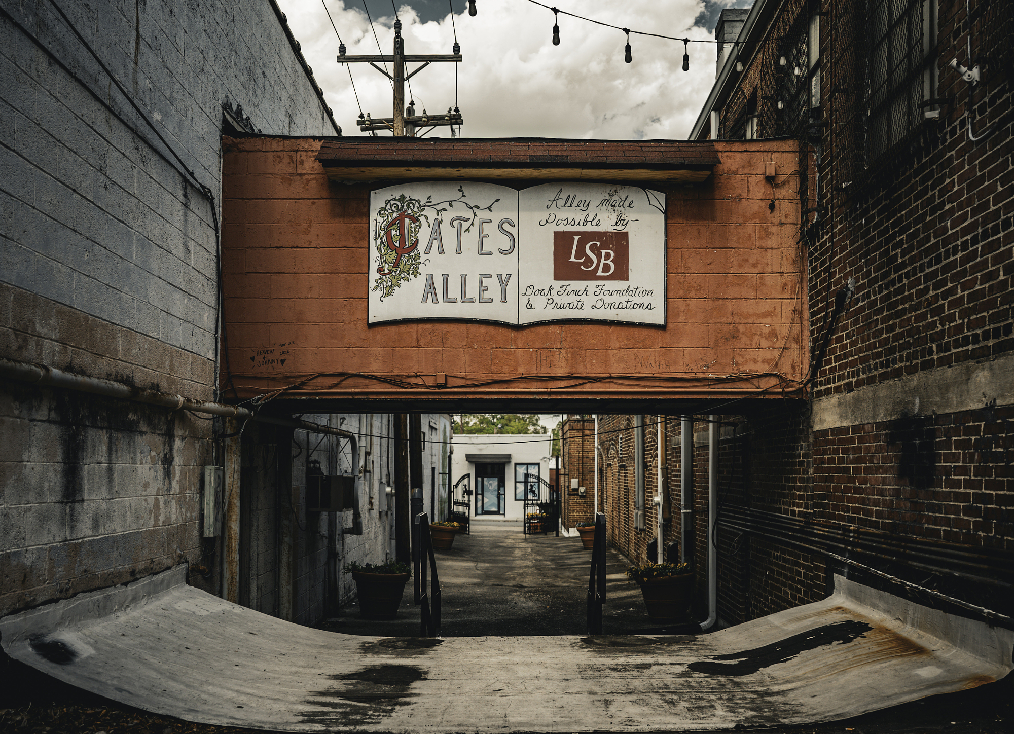 David Baca urban photography of Pates Alley sign between brick buildings in a narrow city alley