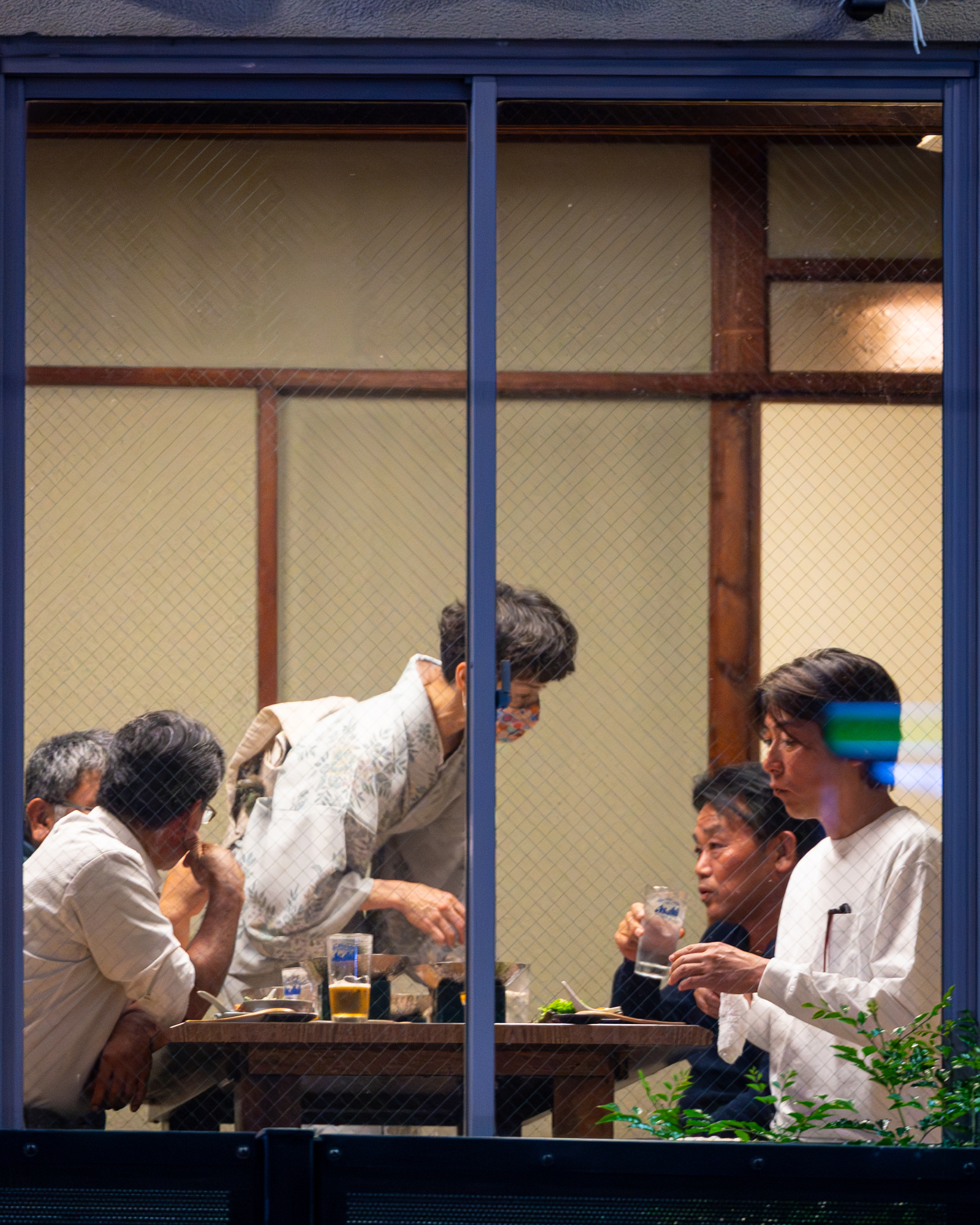 Japanese Diners Through Rrestaurant Window by Cenk Salfur