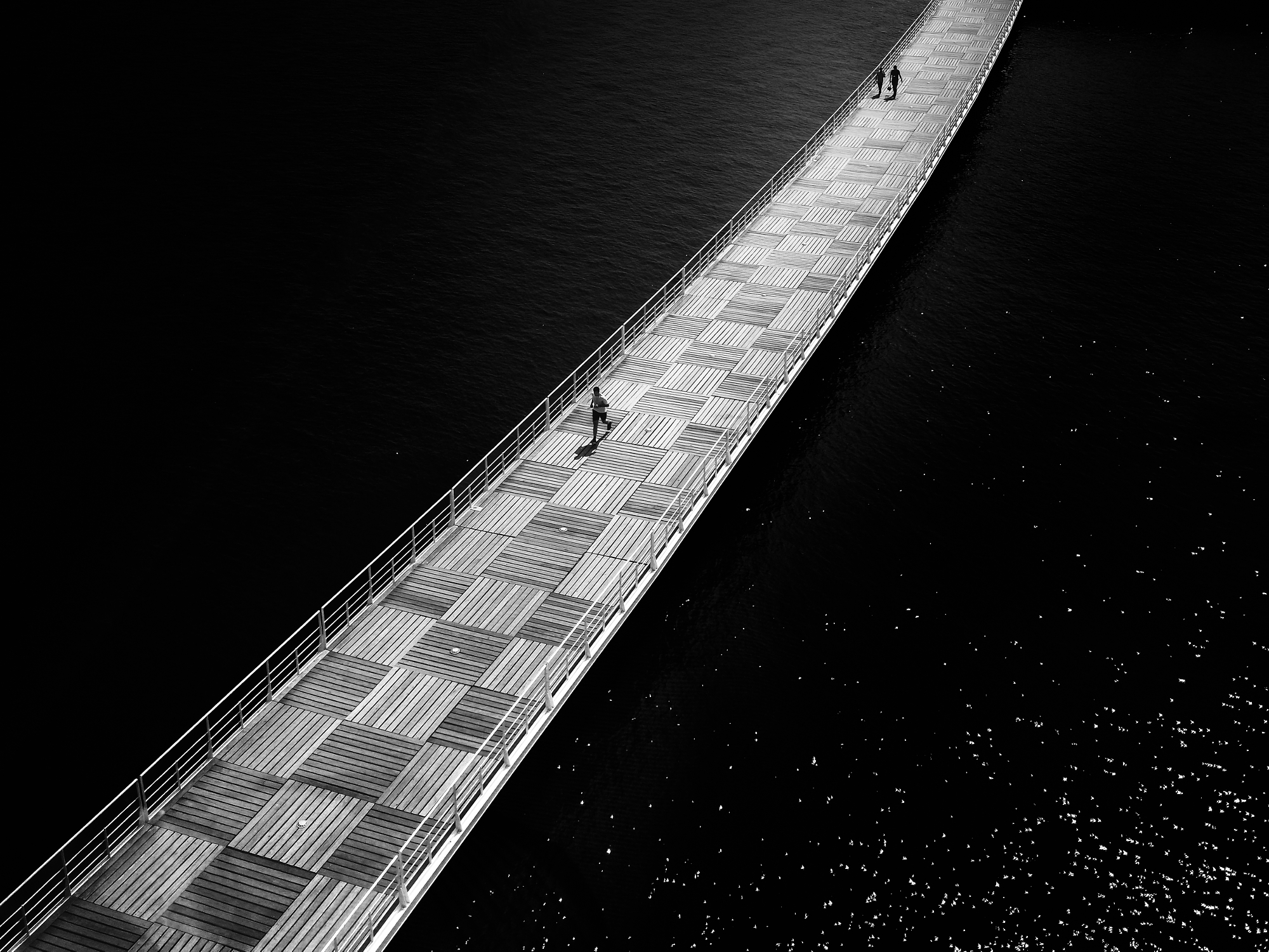 Fine art photography interview showcasing a long bridge over dark water.