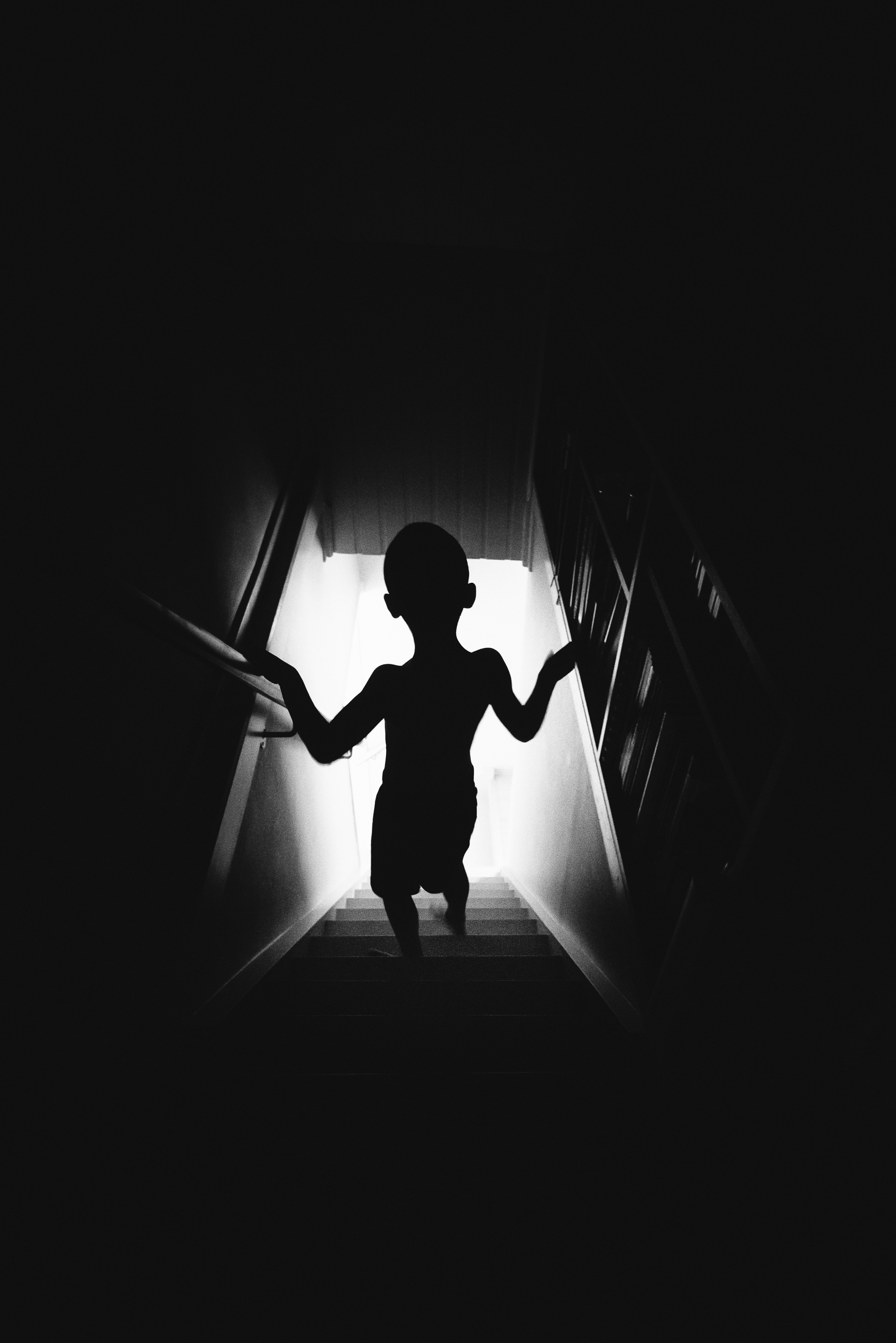 Fine art photography interview image of a child silhouette on stairs.