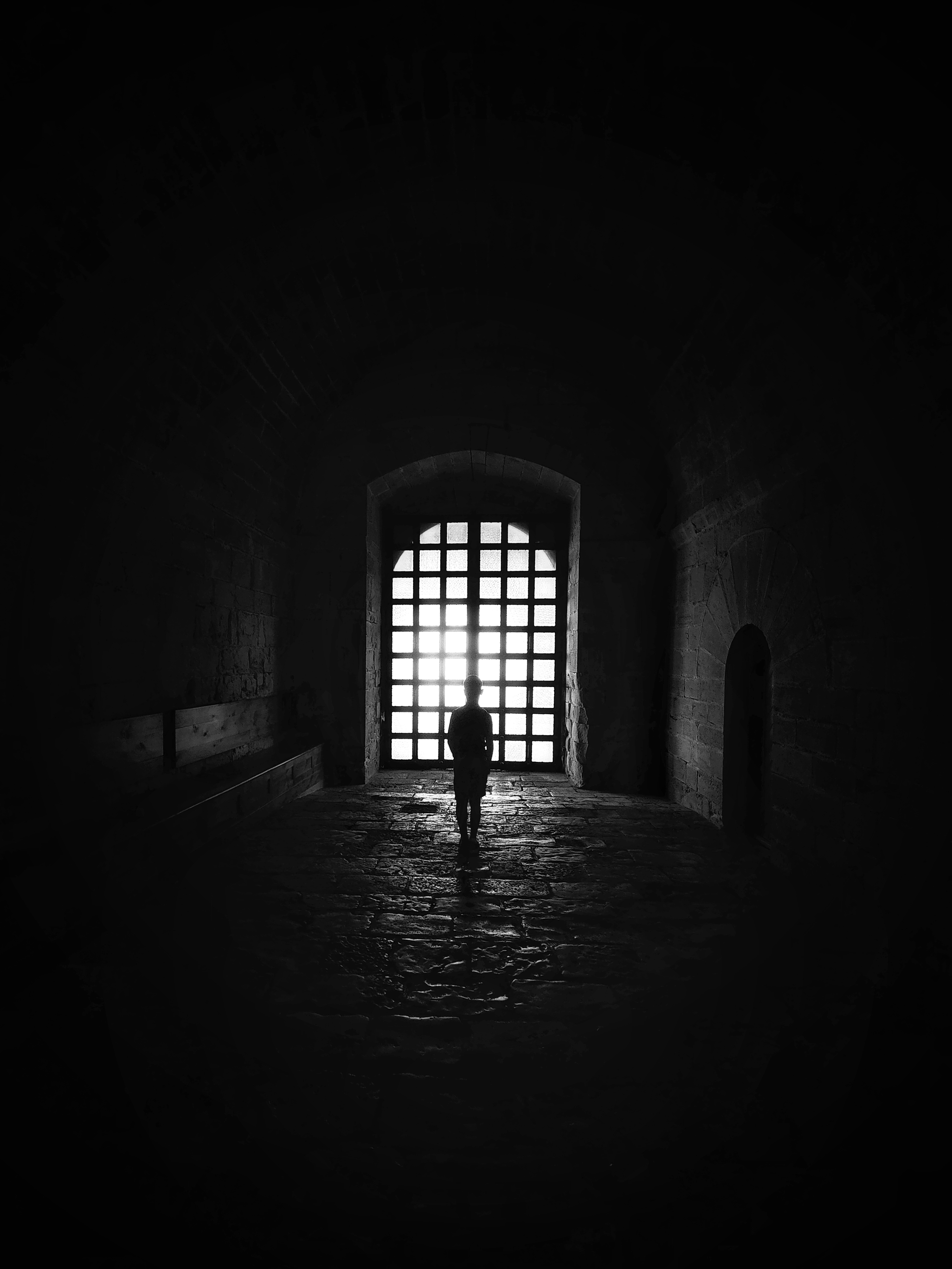 Fine art photography interview image of a silhouette by a grid window.