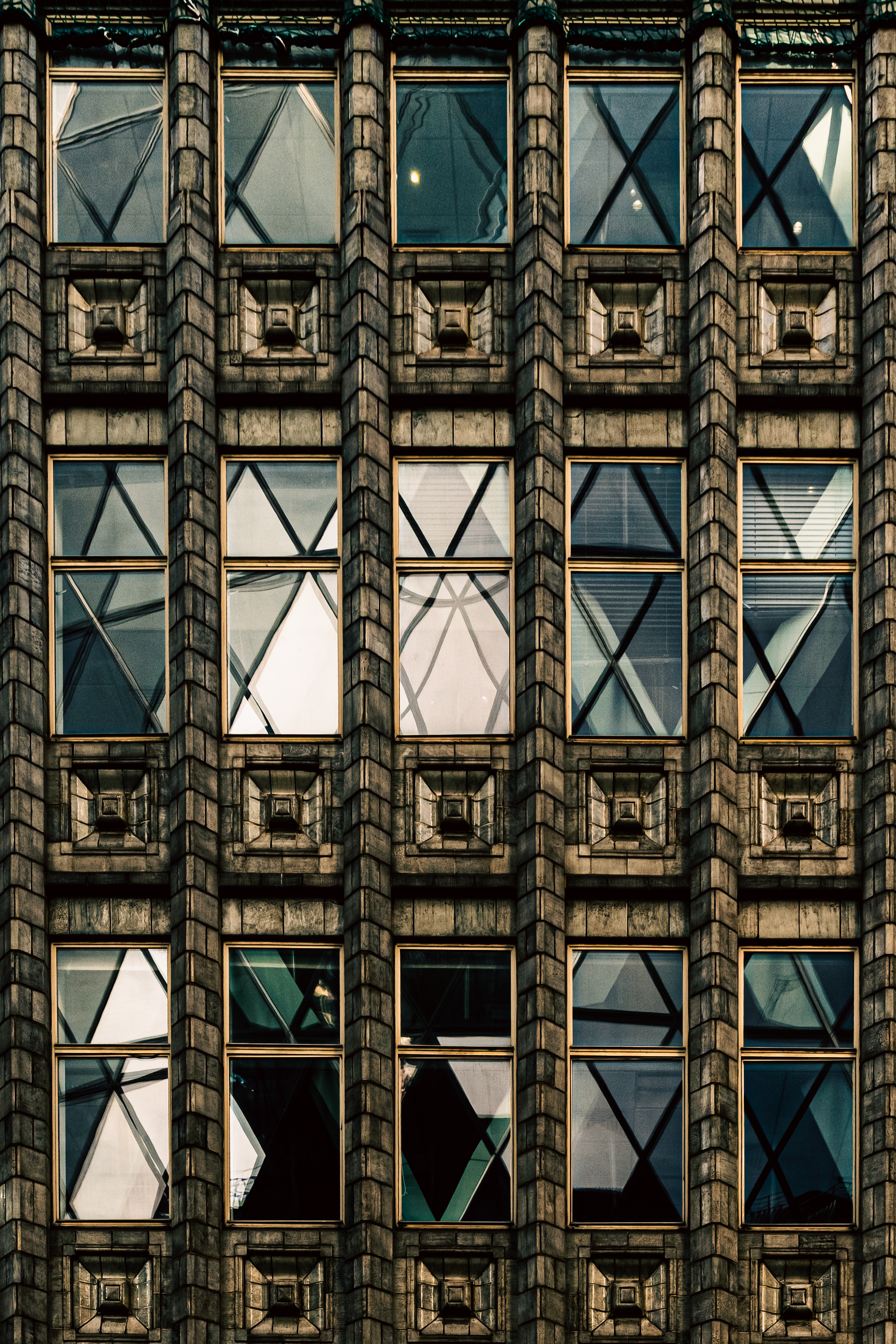 Art deco facade where diagonal reflections turn every window into a different pattern