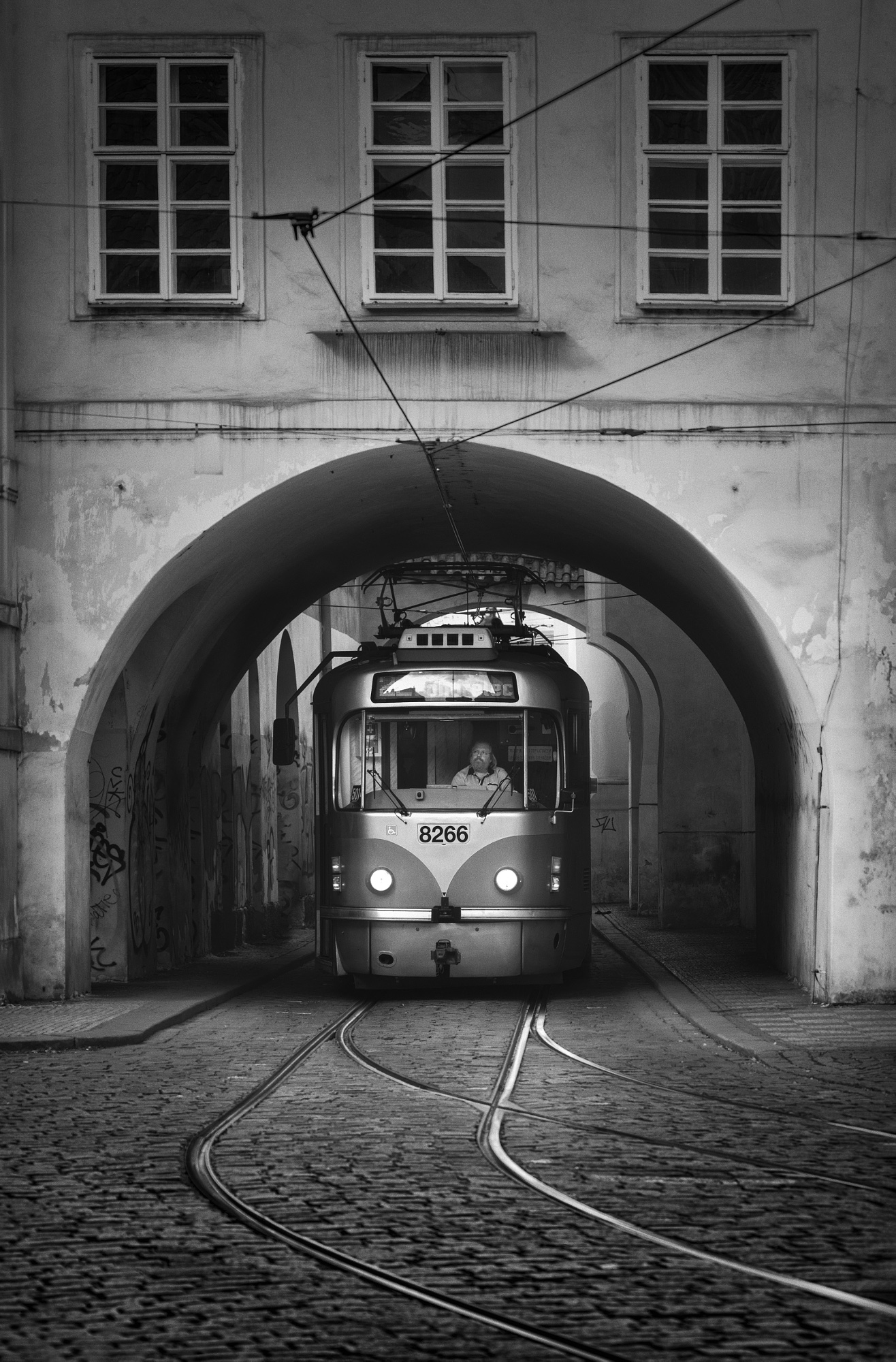 Train arriving at an elevated Hamburg harbor station during blue hour