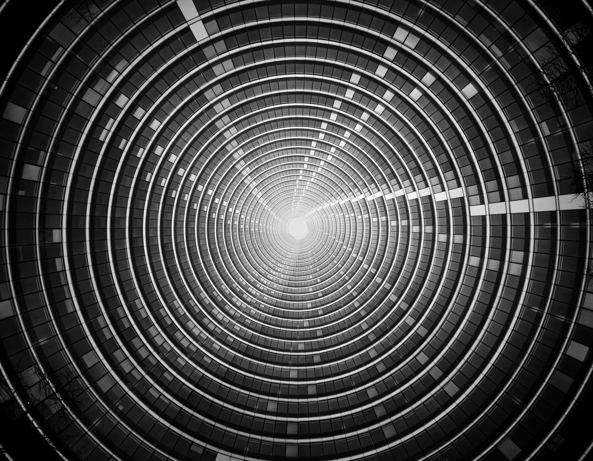 Concentric rings of a circular building interior spiraling toward a bright center