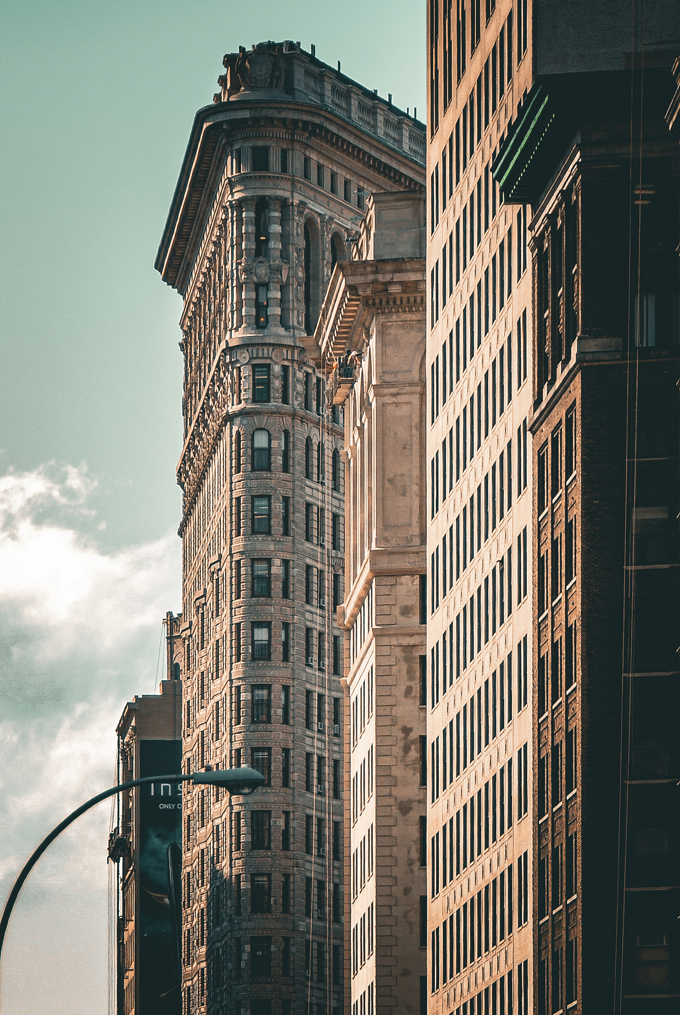 The Flatiron Building framed tightly between two neighboring facades in New York