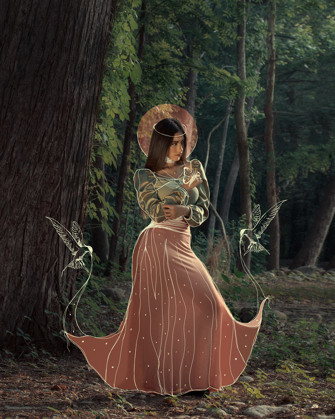 Portrait of a woman in a forest with illustrated birds and a halo drawn over the photograph