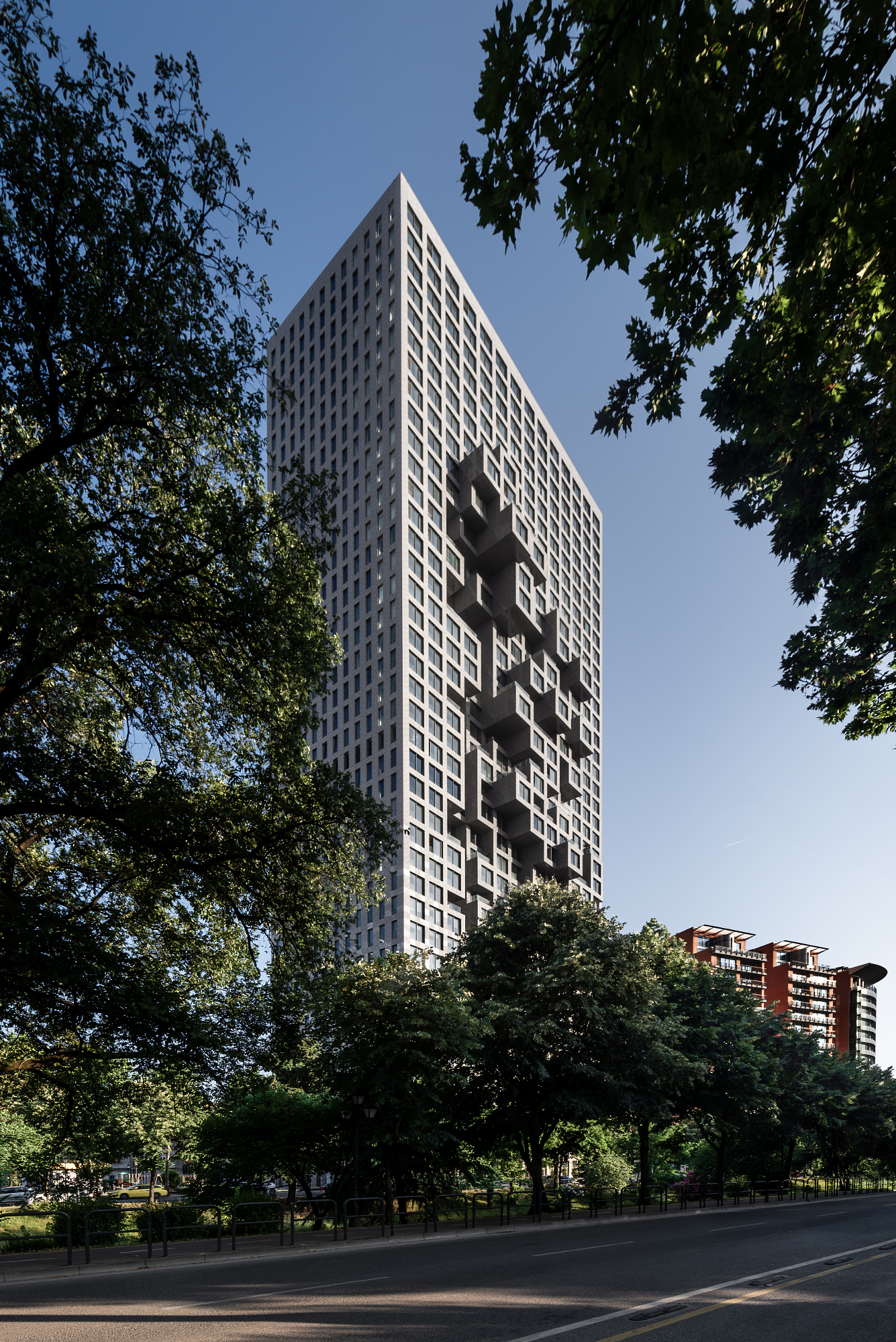 Tirana tower whose projecting balconies form a pixelated map of Albania, captured in Andrew Shenouda's architectural photography.